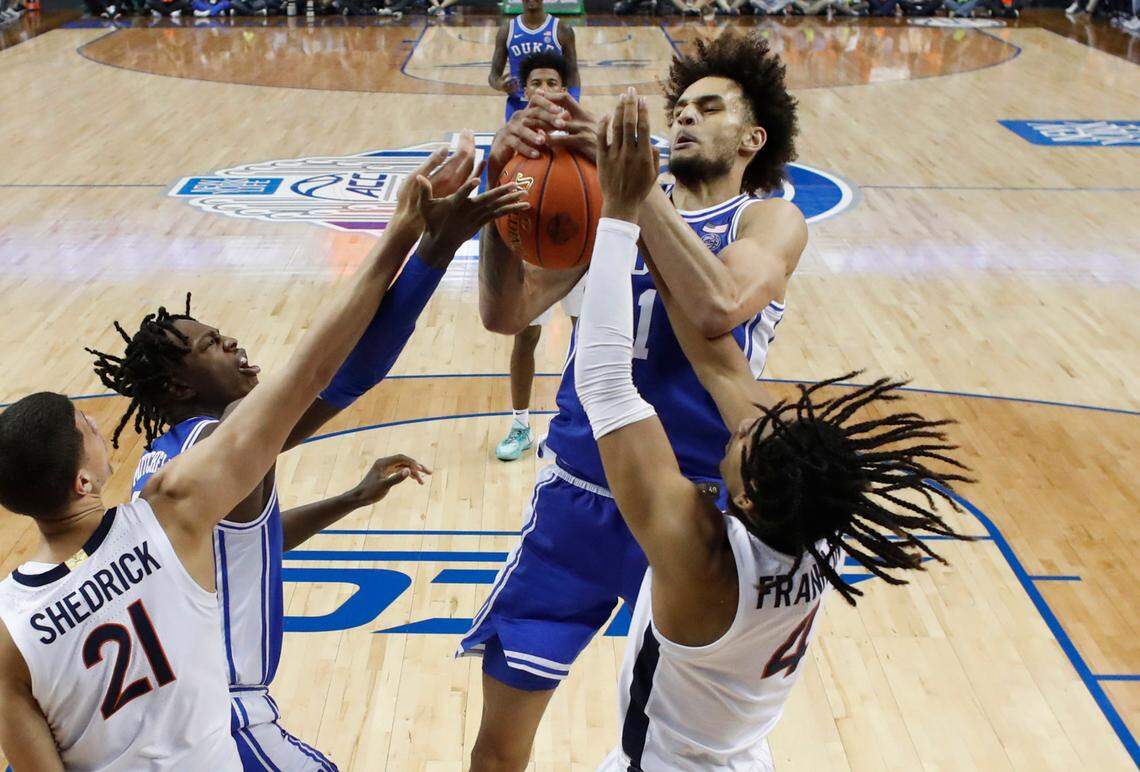 Duke’s Dereck Lively II (1) pulls in a rebound from Virginia’s Armaan Franklin (4) during Duke’s 59-49 victory over Virginia to win the ACC Men’s Basketball Tournament in Greensboro, N.C., Saturday, March 11, 2023.