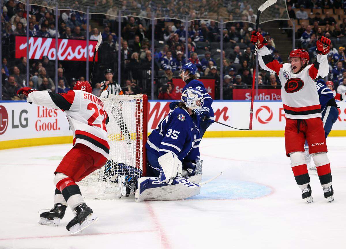 Logan Stankoven, left, of the Carolina Hurricanes celebrates his third period game-winning goal against Toronto goalie Dennis Hildeby, and is joined by Jackson Blake, right, at Scotiabank Arena on Nov. 9, 2025 in Toronto, Ontario, Canada. The Hurricanes defeated the Maple Leafs, 5-4.