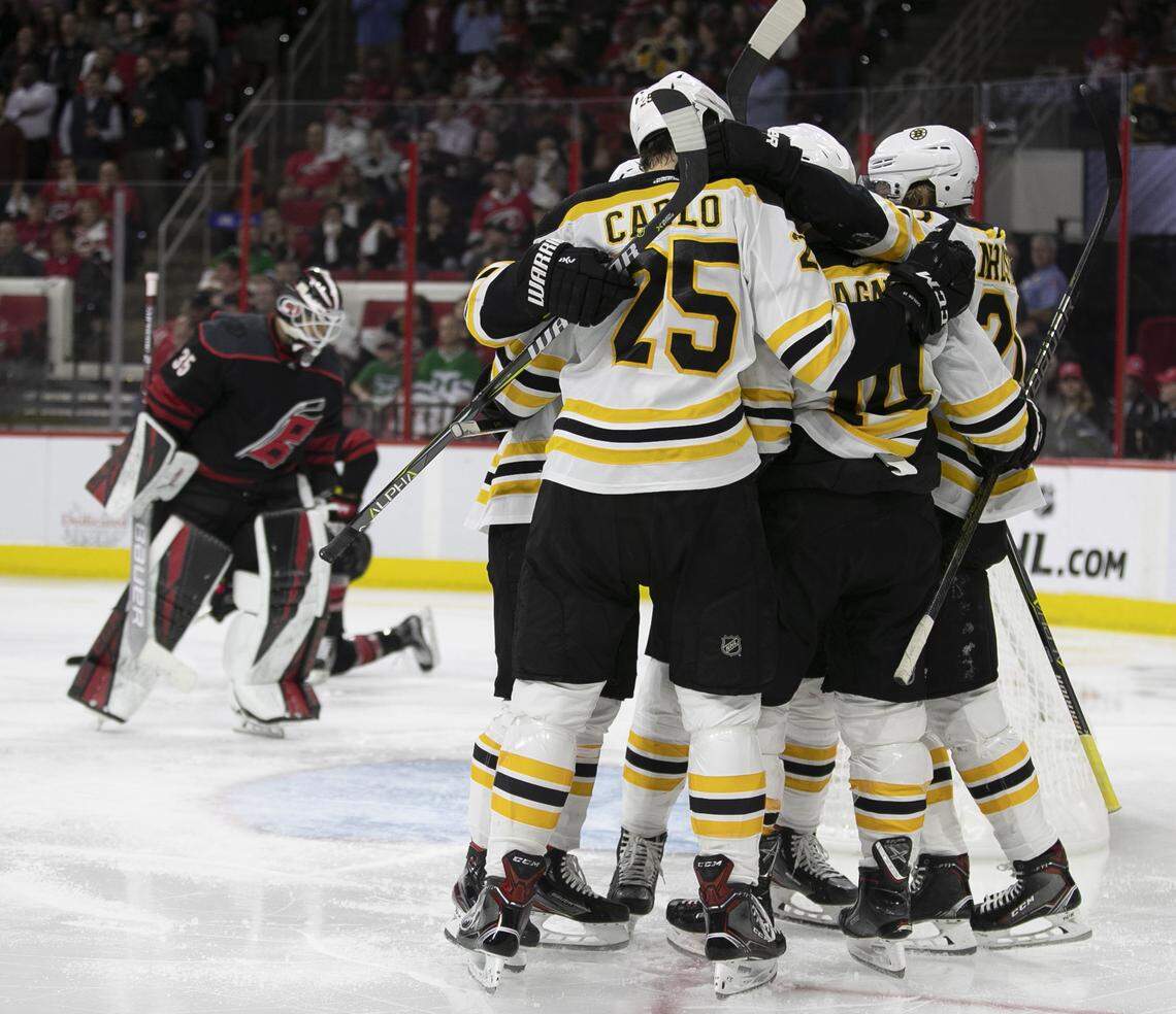 Boston Bruins’ Chris Wagner (14) is surrounded by teammates as they celebrate Wagner’s goal during the second period against the Carolina Hurricanes in Game 3 of the Eastern Conference finals on Tuesday, May 14, 2019 at PNC Arena in Raleigh, N.C