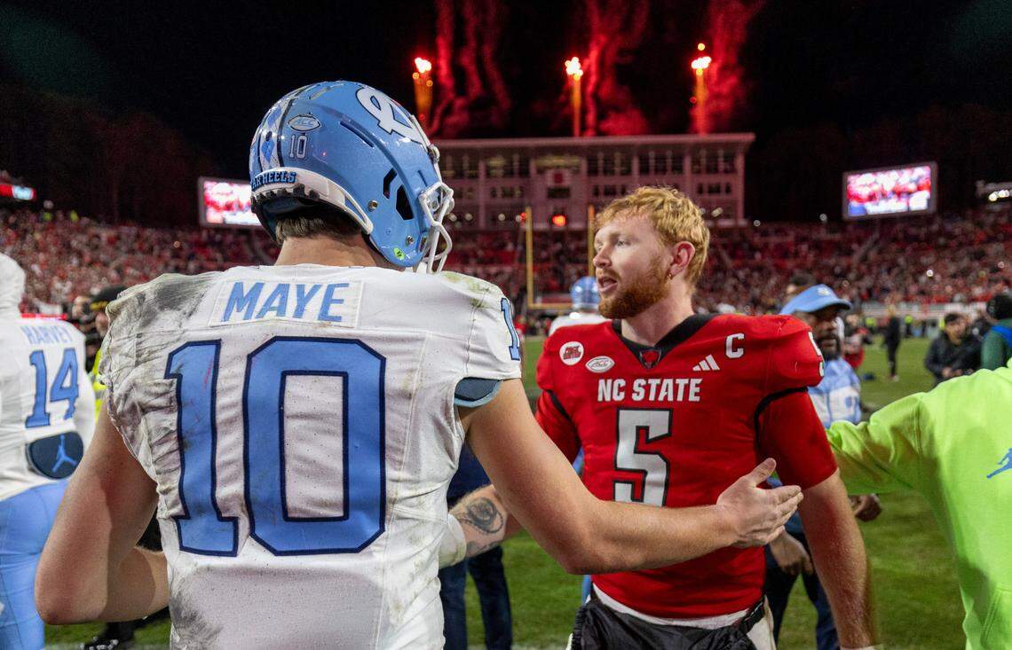 North Carolina quarterback Drake Maye (10) congratulates N.C. State quarterback Brennan Armstrong (5) following the Wolfpack’s 39-20 victory on Saturday, November 25, 2023 at Carter-Finley Stadium in Raleigh, N.C.