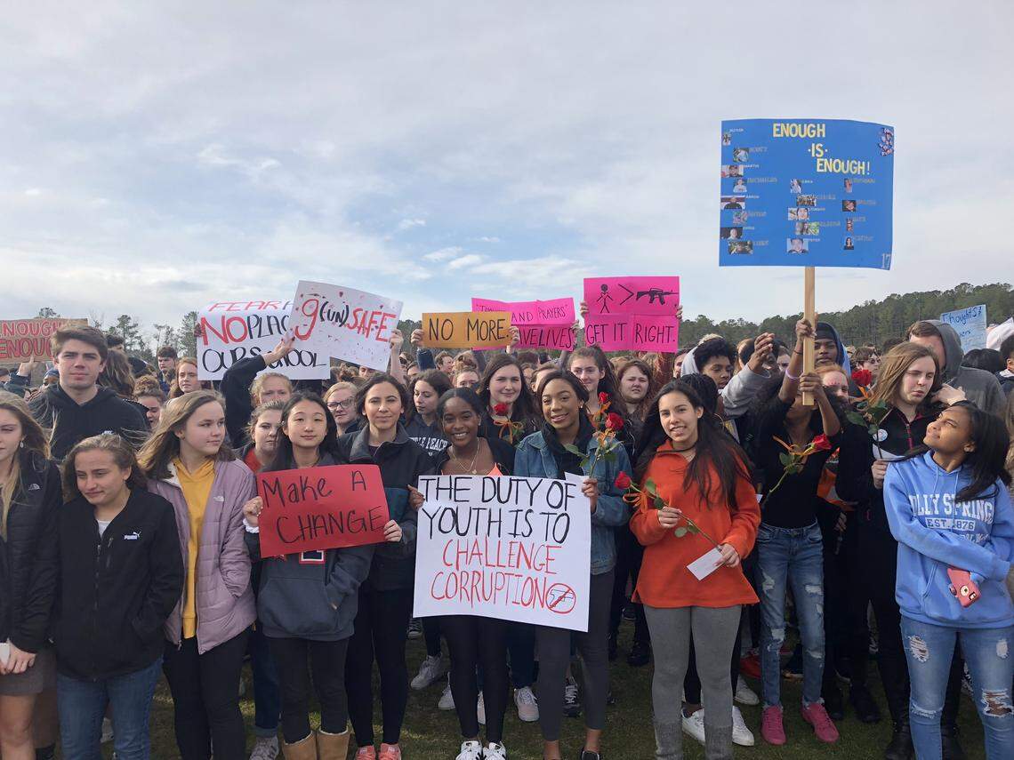 Apex Friendship High School students hold signs calling for end to school gun violence as part of a school walkout on March 14, 2018 in Apex, N.C., held on the one-month anniversary of the school shootings in Parkland, Fla.