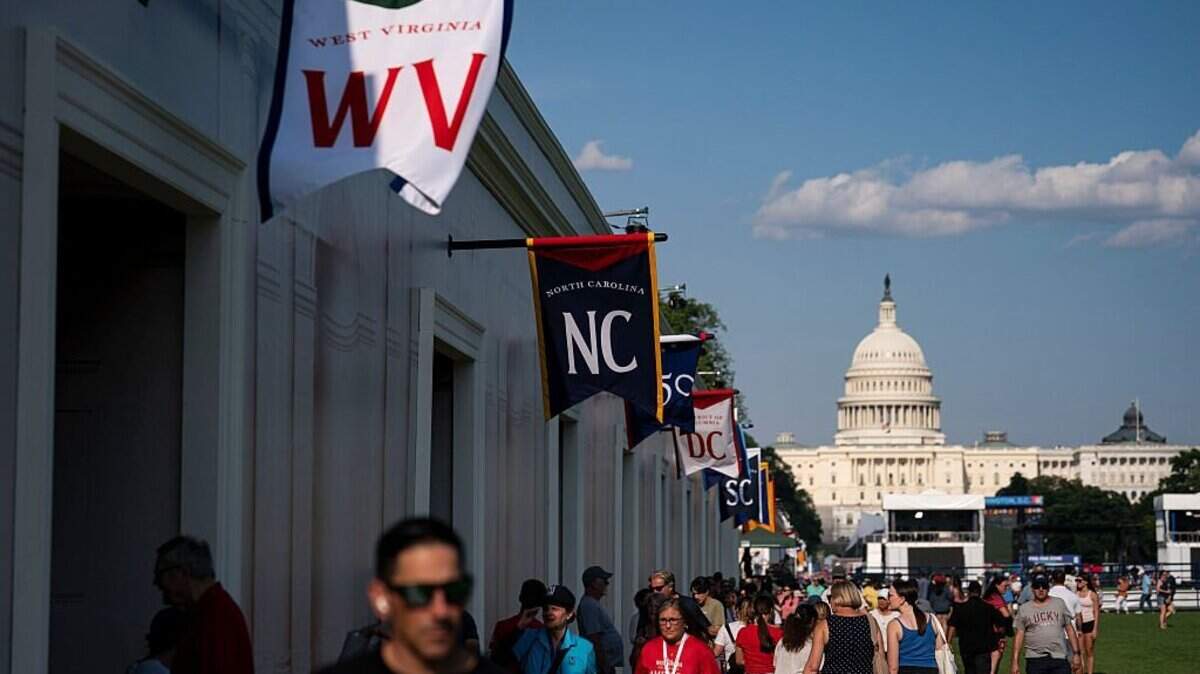 WASHINGTON, DC - JUNE 25: Visitors walk past the West Virginia and North Carolina exhibits on the first day of the "Great American State Fair" on the National Mall on June 25, 2026 in Washington, DC. The Freedom 250-backed Great American State Fair celebrating the 250th anniversary of the United States runs through July 10th. (Photo by Al Drago/Getty Images)