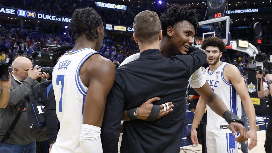 Duke head coach Jon Scheyer hugs Patrick Ngongba II (21) after Duke’s 68-63 victory over Michigan in the Capital Showcase at Capital One Arena in Washington, D.C., Saturday, Feb. 21, 2026.