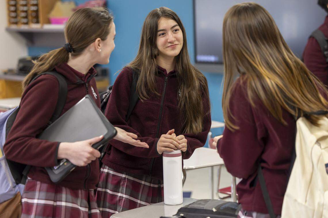 Romina Gonzales, center, talks with her friends at the end of class at St. Catherine of Siena Catholic School on Thursday, Feb. 12, 2026.