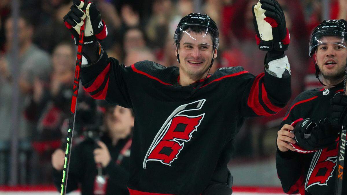 Oct 27, 2023; Raleigh, North Carolina, USA; Carolina Hurricanes defenseman Dmitry Orlov (7) celebrate their victory against the San Jose Sharks after the game at PNC Arena. Mandatory Credit: James Guillory-USA TODAY Sports
