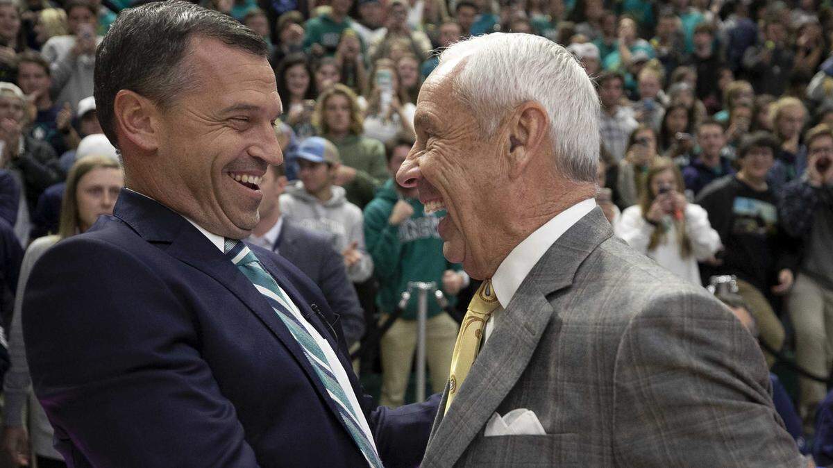 North Carolina coach Roy Williams embraces UNC-Wilmington coach C.B. McGrath prior to their game on Friday, November 8, 2019 at Trask Coliseum in Wilmington, N.C. McGrath was a long time assistant for Williams before taking the head coaching job in Wilmington.