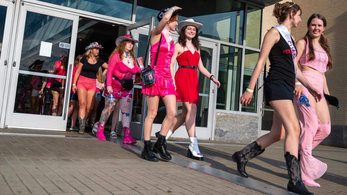Fans in their pink-themed regalia make their way from the Raleigh Convention Center to Red Hat Amphitheater for Chappell Roan’s concert in Raleigh.