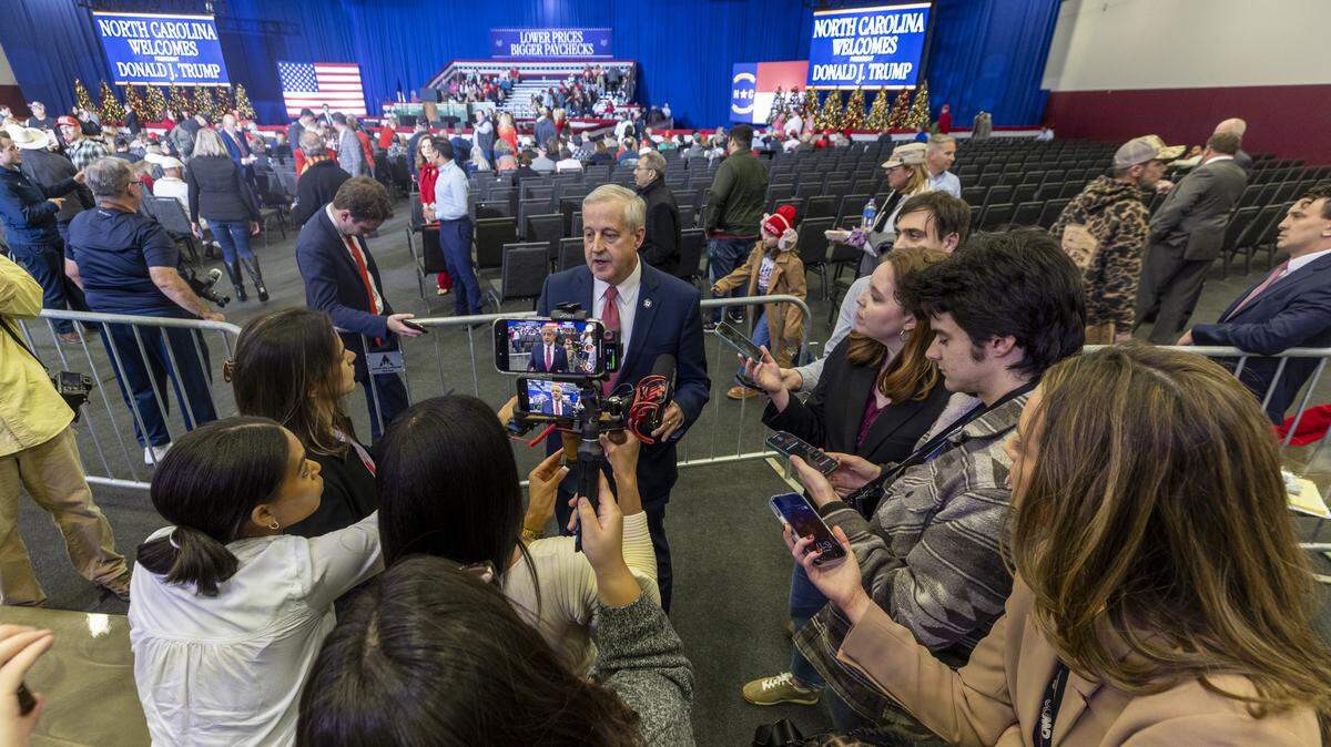 Former Republican National Committee chair and U.S. Senate Republican primary candidate Michael Whatley talks with reporters before a rally featuring President Donald Trump at the Rocky Mount Event Center in Rocky Mount on Friday, Dec. 19, 2025. Whatley was endorsed by Trump in July.