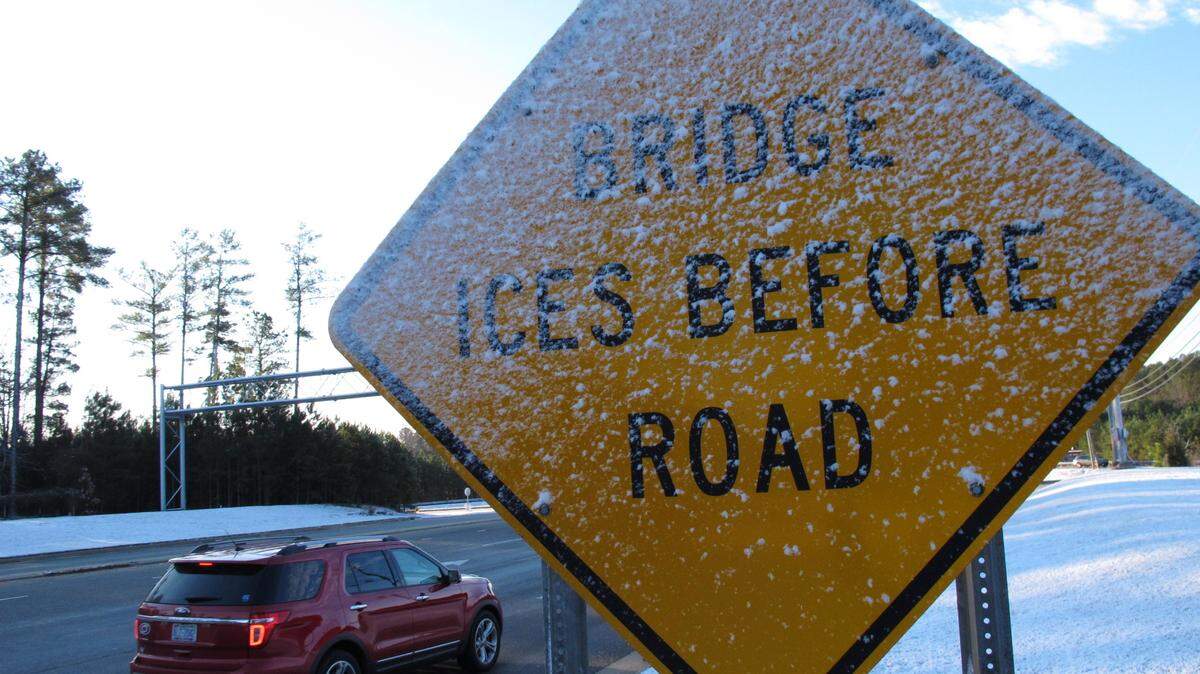Icy snow plasters a warning sign near Interstate 540 in Raleigh, N.C., on Wednesday, Jan. 22, 2014. The Midlands SC area is expected to see an ice storm this weekend.