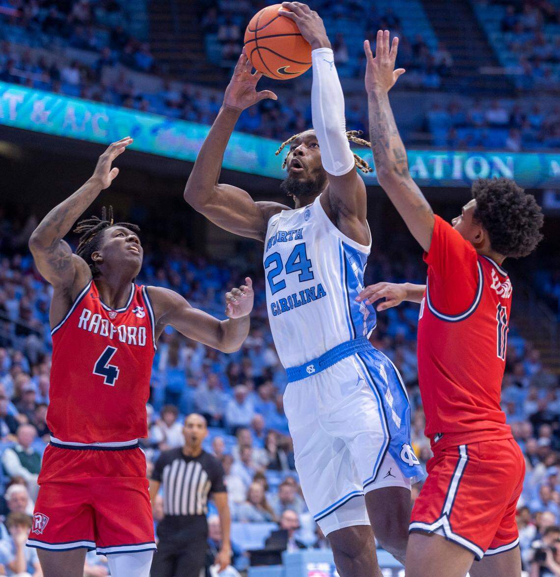 North Carolina’s Jae’Lyn Withers (24) drives to the basket against Radford’s Truth Harris (4) and Kyle Burns (11) in the first half on Monday, November 6, 2023 at the Dean Smith Center in Chapel Hill, N.C.