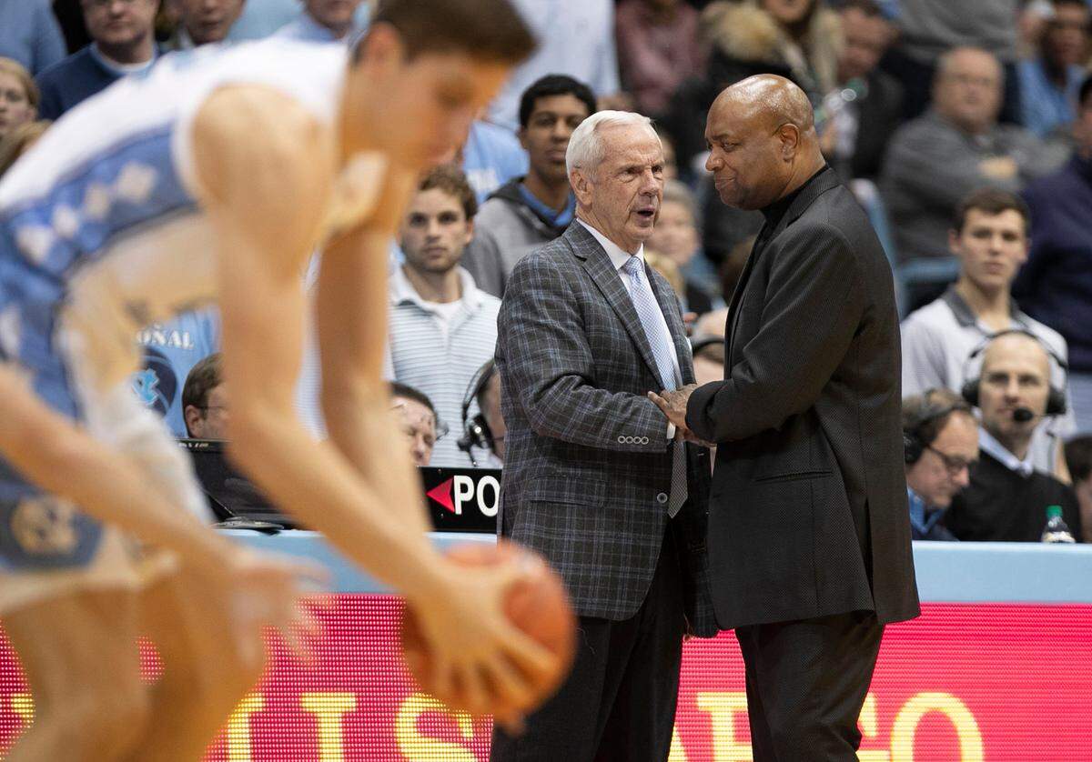 Florida State coach Leonard Hamilton congratulates North Carolina coach Roy Williams during the final seconds of play on Saturday, February 23, 2019 at the Smith Center in Chapel Hill, N.C.