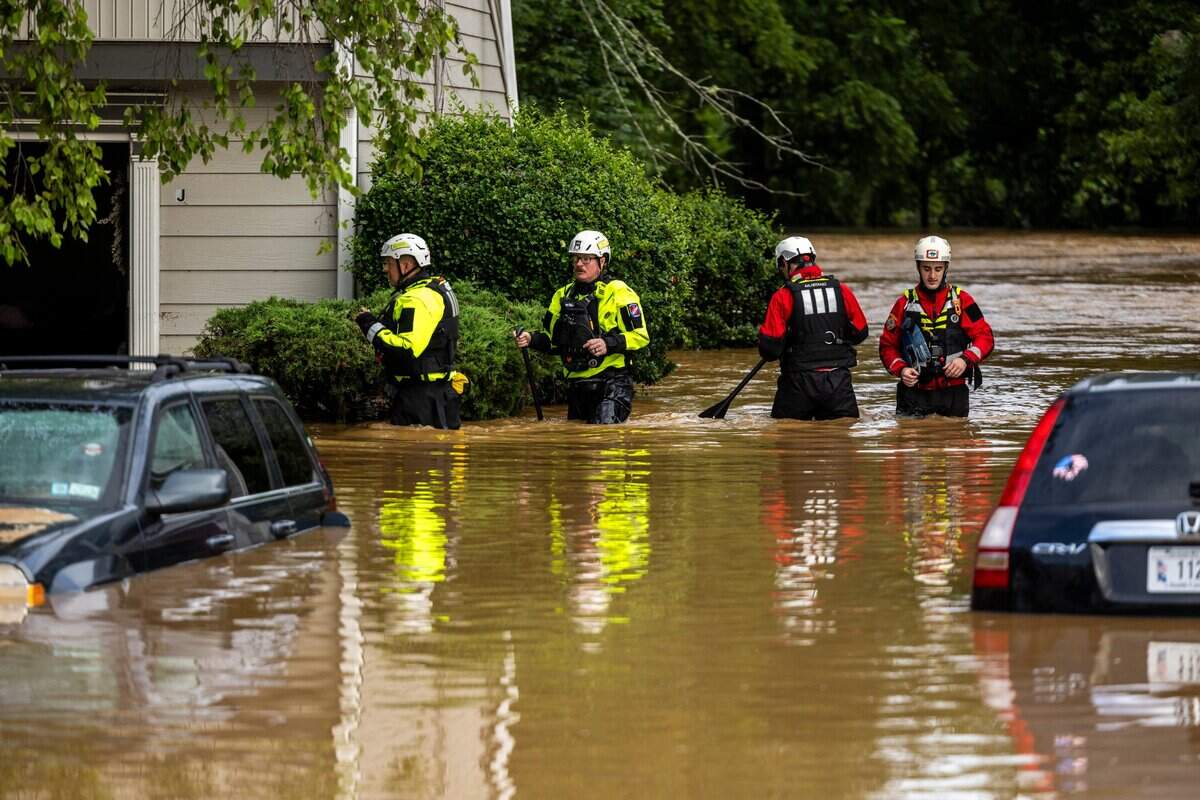 A water rescue unit with the Durham Fire Department knocks on doors at Rippling Streams Townhomes in the Old Farm neighborhood along the Eno River in Durham on Monday morning, July 7, 2025, after flash flooding caused by Tropical Storm Chantal.