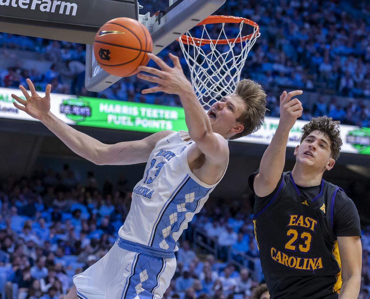 North Carolina center Henri Veesaar (13) works to secure an offensive rebound against East Carolina forward Reid Cason (23) in the second half on Monday, December 22, 2025 at the Smith Center in Chapel Hill, N.C. Veesaar scored 16 points and collected 10 rebounds in the Tar Heels’ 99-51 victory