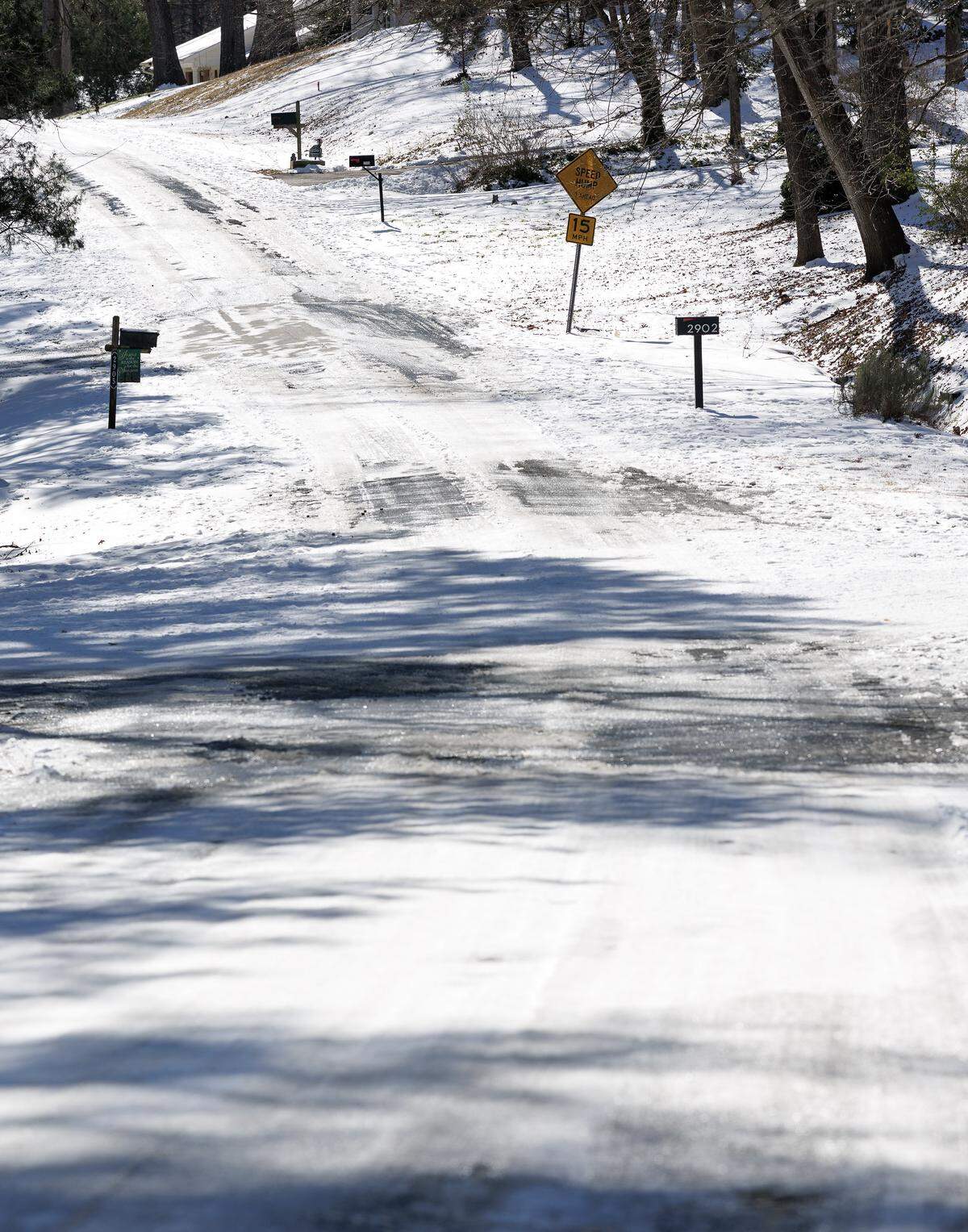 Snow and ice partially cover a neighborhood street off of West Cornwallis Road on Monday, Feb. 2, 2026, in Durham, N.C. 