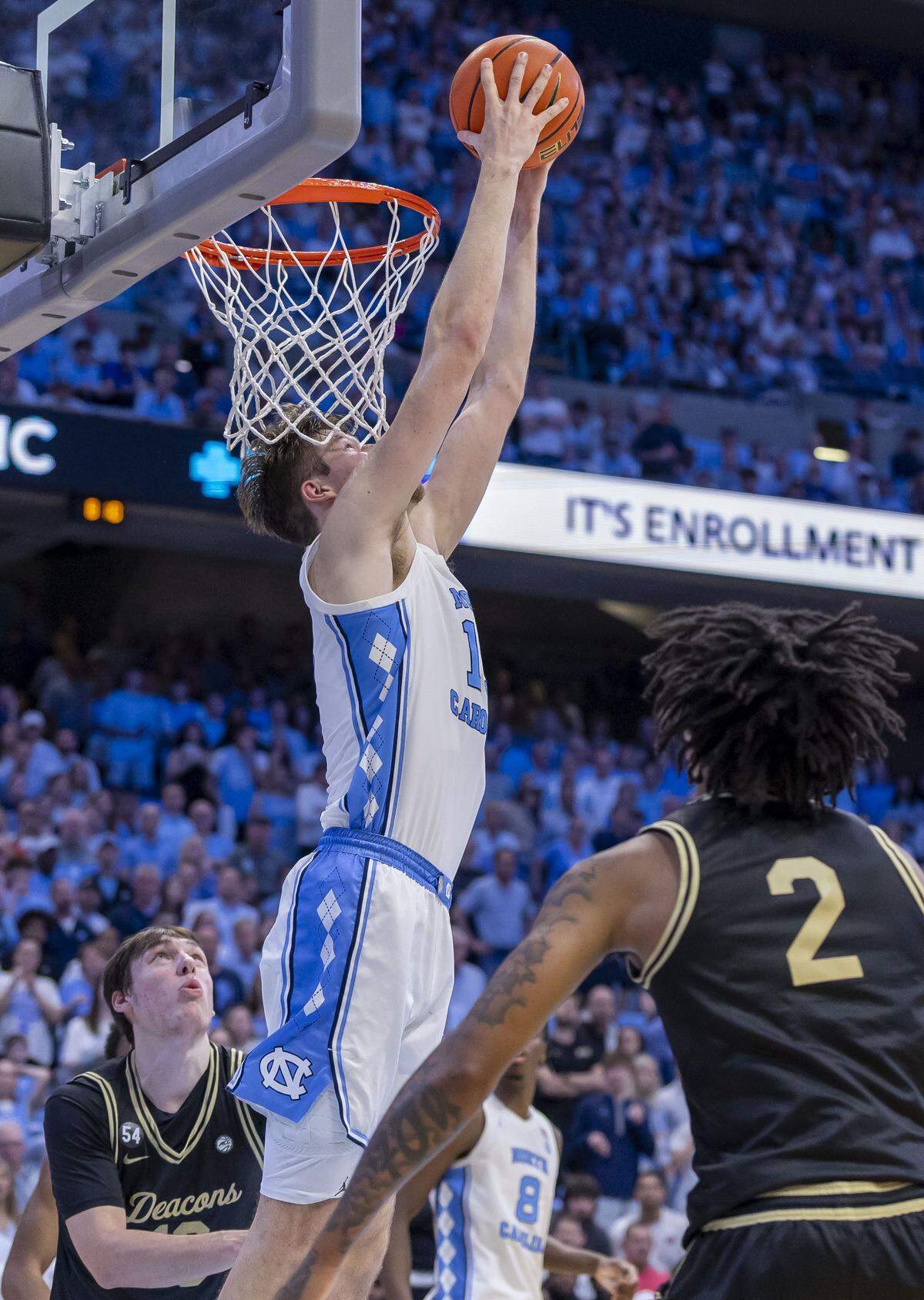 North Carolina center Henri Veesaar (13) does a reverse dunk against Wake Forest forward Cooper Schwieger (13) and guard Juke Harris (2) to give the Tar Heels an 80-76 lead with under two minutes to play on Saturday, January 10, 2026 at the Smith Center in Chapel Hill, N.C. 