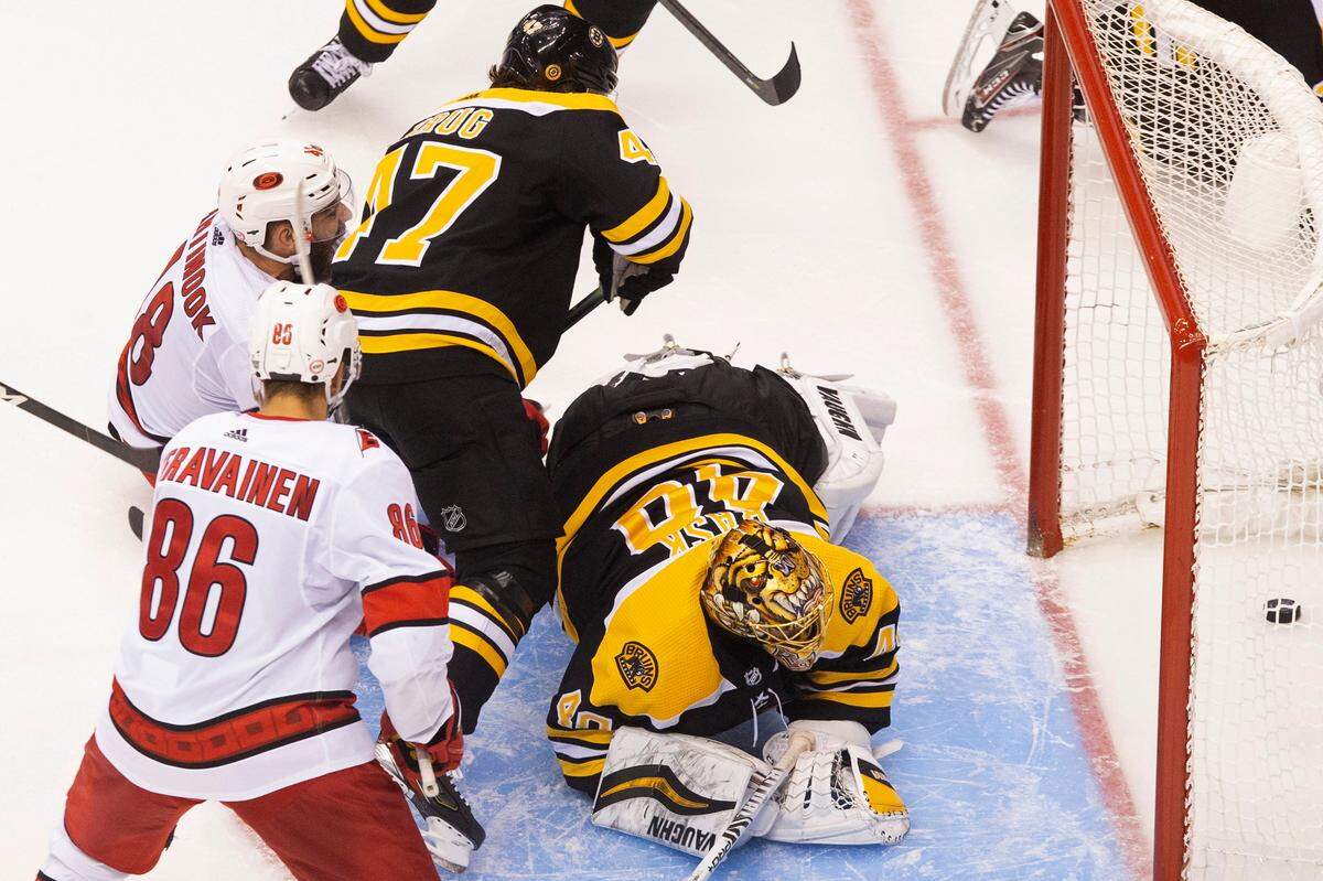 Boston Bruins goaltender Tuukka Rask (40) watches the puck cross the line on what would be ruled no goal due to goalie interference as Carolina Hurricanes’ Teuvo Teravainen (86), Hurricanes’ Jordan Martinook (48) and Bruins’ Torey Krug (47) look on during third-period NHL hockey first-round Stanley Cup playoff action in Toronto, Thursday, Aug. 13, 2020. (Chris Young/The Canadian Press via AP)