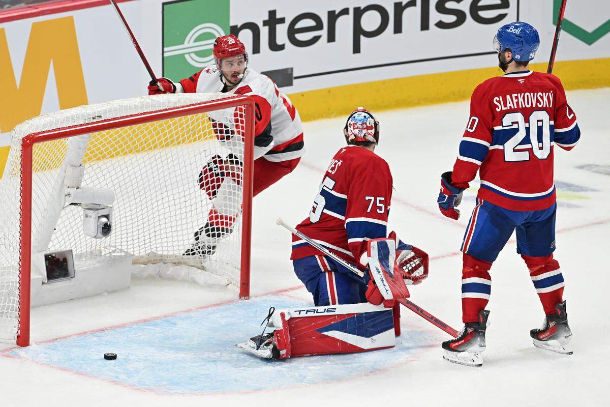 Carolina Hurricanes forward Sebastian Aho, left, celebrates as the puck gets past Montreal Canadiens goalie Jakub Dobes on a shot by the Hurricanes’ Andrei Svechnikov (not pictured) during overtime of Game 3 of the Eastern Conference Final of the 2026 Stanley Cup Playoffs at Bell Centre on May 25, 2026 in Montreal, Quebec, Canada.