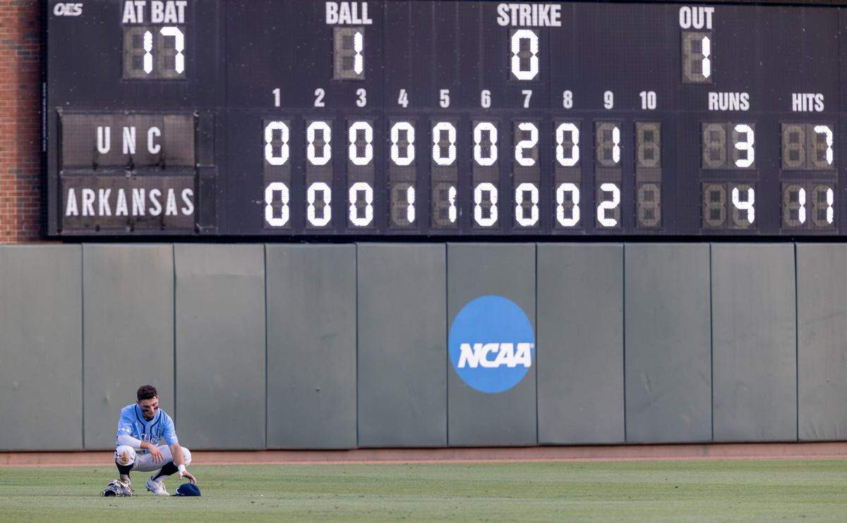North Carolina left fielder Mikey Madej (2) gathers his thoughts alone in left field following the Tar Heels 4-3 loss to Arkansas in the NCAA Super Regional series on Sunday, June 12, 2022 at Boshamer Stadium in Chapel Hill, N.C.