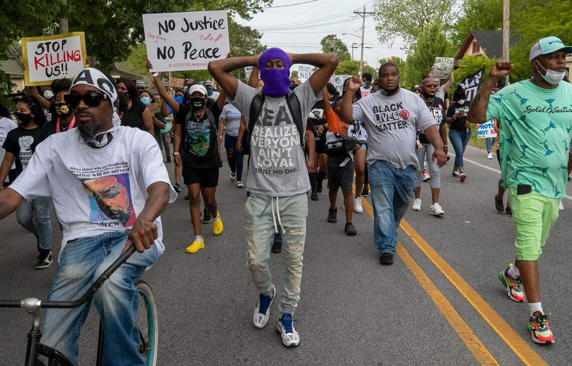 Elizabeth City Councilman Gabriel Adkins, right, leads demonstrators on a march through Andrew Browns neighborhood on Thursday, April 29, 2021 in Elizabeth City, N.C. This is the ninth day of demonstrations in the wake of Andrew Brown Jr.s death at the hands of Pasquotank County deputies.