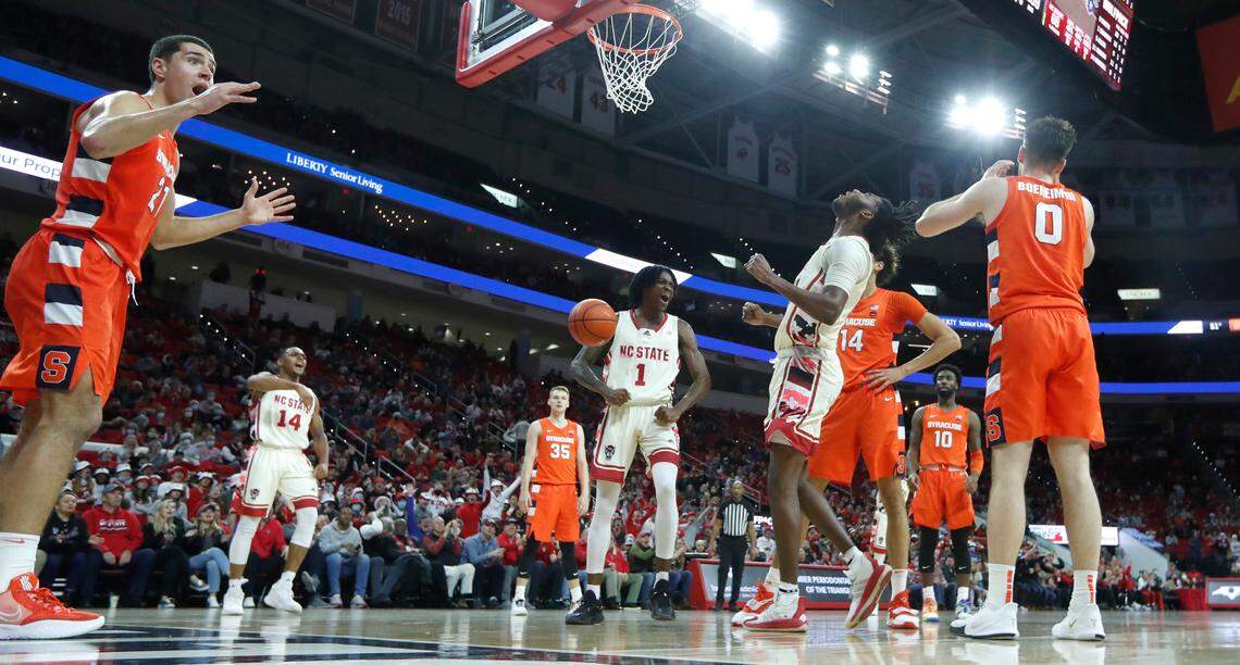 N.C. State’s Jaylon Gibson (11), center, and teammates Dereon Seabron (1) and Casey Morsell (14) react after Gibson made the basket while being fouled during Syracuse’s 89-82 victory over N.C. State at PNC Arena in Raleigh, N.C., Wednesday, Feb. 2, 2022.