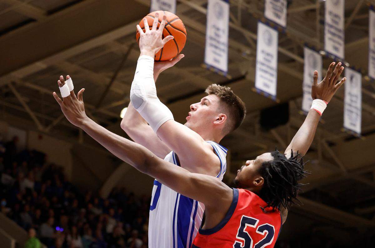 Duke’s Kyle Filipowski (30) shoots as Southern Indiana’s Kiyron Powell (52) defends during the second half of Duke’s 80-62 victory over Southern Indiana at Cameron Indoor Stadium in Durham, N.C., Friday, Nov. 24, 2023.