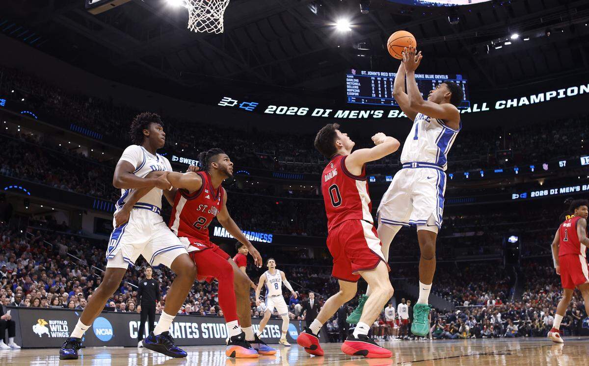 Duke’s Caleb Foster (1) shoots over St. John's Dylan Darling (0) during Duke’s 80-75 victory over St. John’s in the Sweet 16 of the NCAA Men’s Basketball East Regional at Capital One Arena in Washington, D.C., Friday, March 27, 2026.