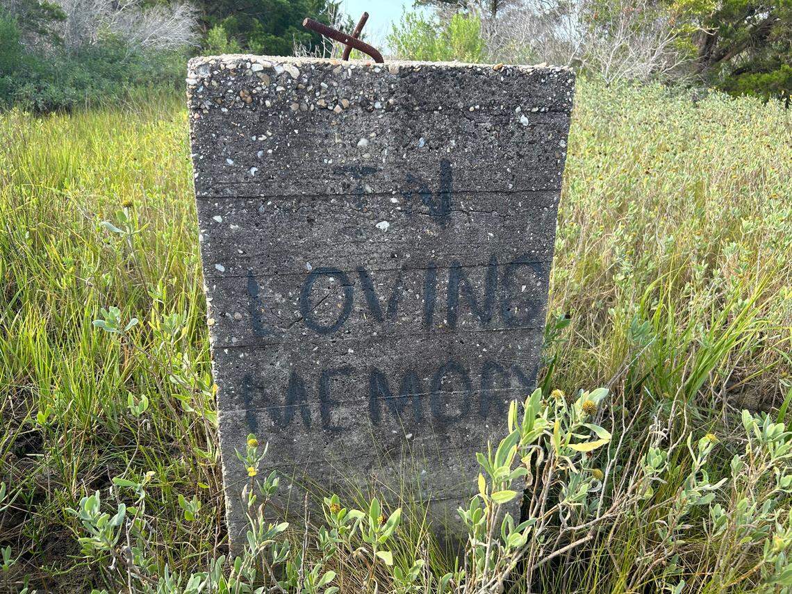 Remains of a gateway to the World War II bunker where Robert Harrill, the Fort Fisher Hermit, lived for 17 years, with a memorial reportedly written by his granddaughter.