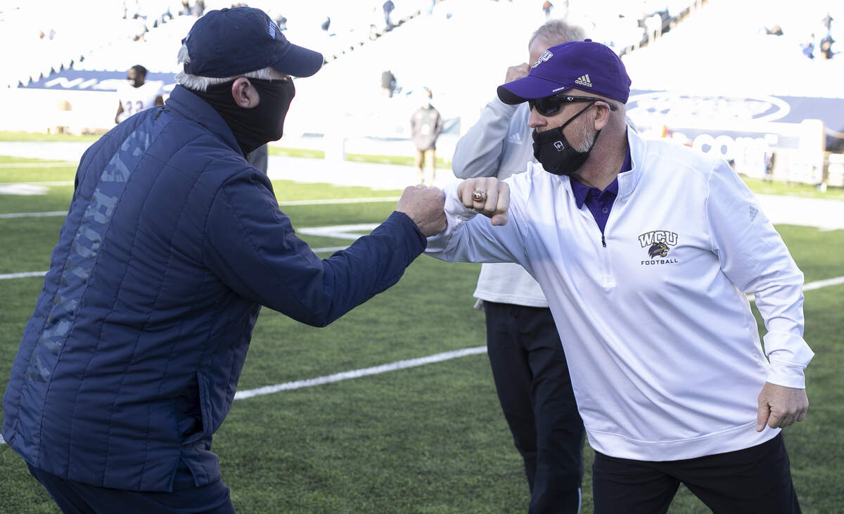 Western Carolina head coach Mark Speir and North Carolina coach Mack Brown meet at mid-field following the Tar Heels’ 49-9 victory on Saturday, December 5, 2020 at Kenan Stadium in Chapel Hill, N.C.
