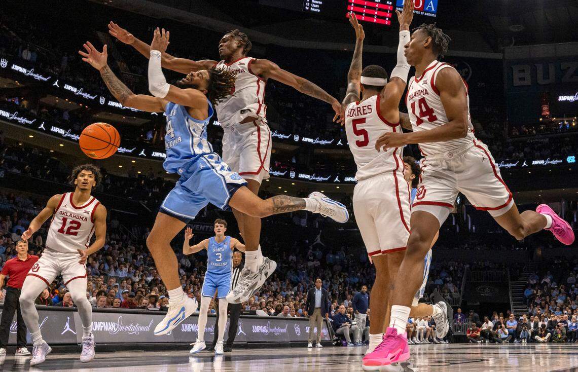 North Carolina’s R.J. Davis (4) loses control of the ball as he drives to the basket under Oklahoma’s Otega Oweh (3) in the first half on Wednesday, December 20, 2023 at the Spectrum Center in Charlotte, N.C.