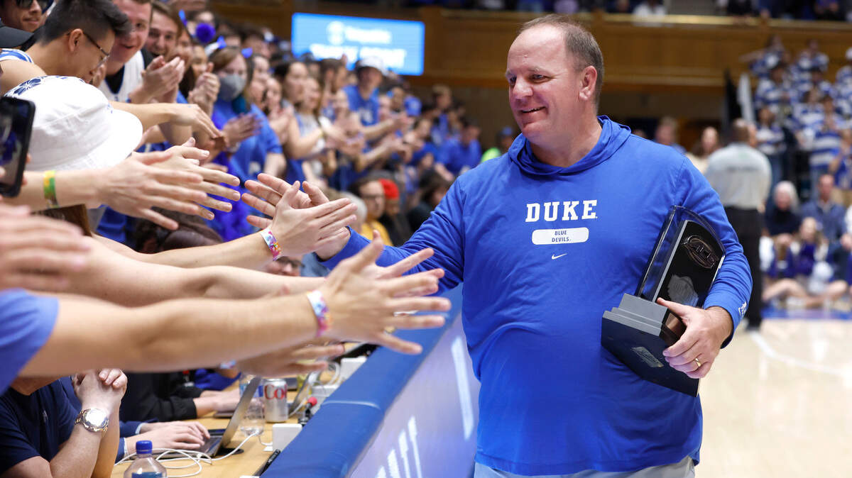 Duke football coach Mike Elko is congratulated by the Cameron Crazies after a ceremony where he was given the ACC Coach of the Year trophy during Duke’s game against Boston College at Cameron Indoor Stadium in Durham, N.C., Saturday, Dec. 3, 2022.