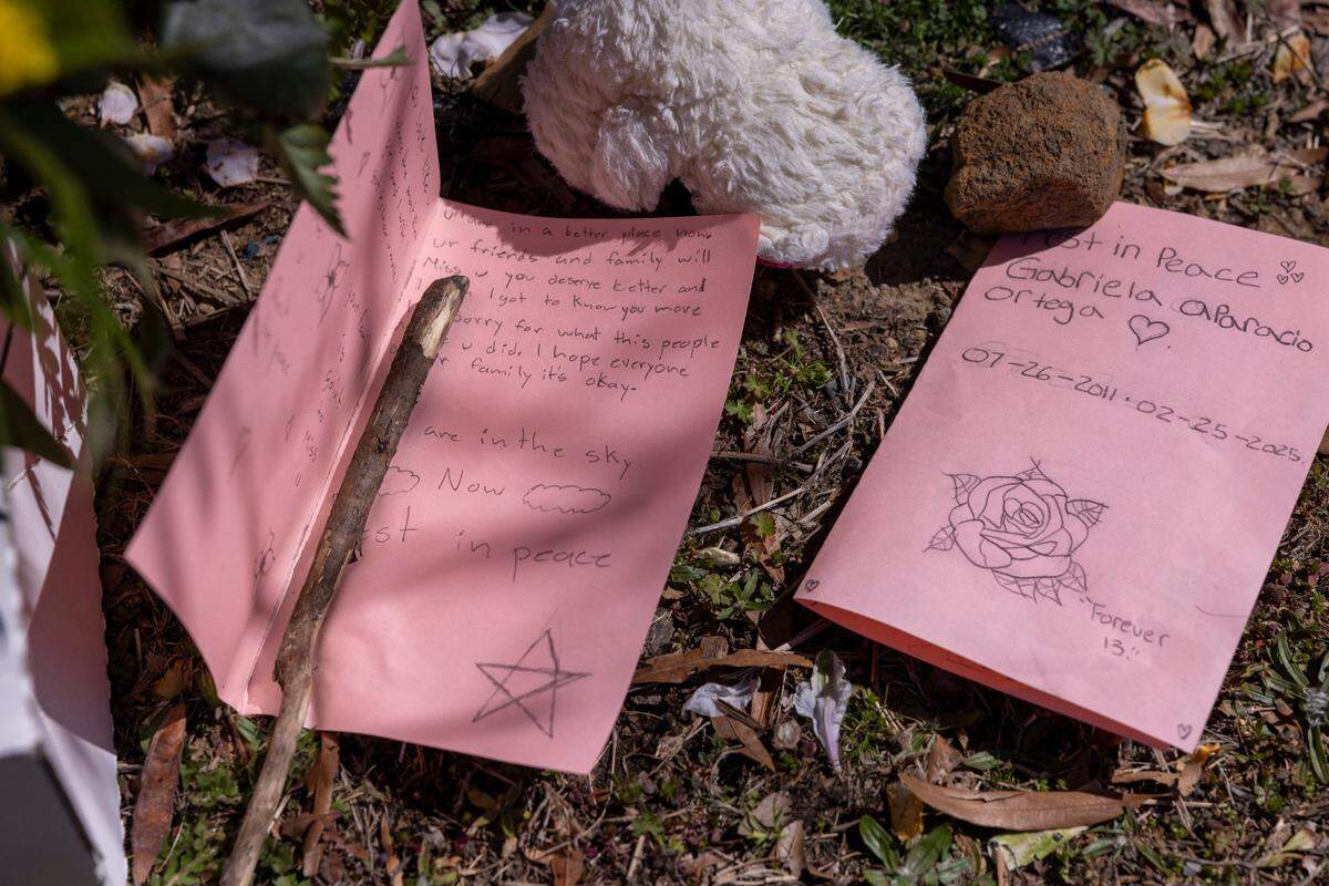 Letters lie at the foot of a makeshift memorial for 13-year-old Gabriela Ortega outside Durham School of the Arts on Tuesday, March 11, 2025. The eighth grader died by suicide last month, according to her family.