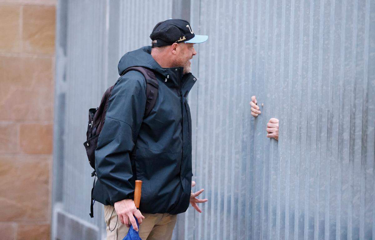 UCLA fan Brad VanRoekel talks with security outside Petco Park in San Diego, CA after UCLA pulled out of the Holiday Bowl, canceling the game hours before kickoff in Tuesday, Dec. 28, 2021.