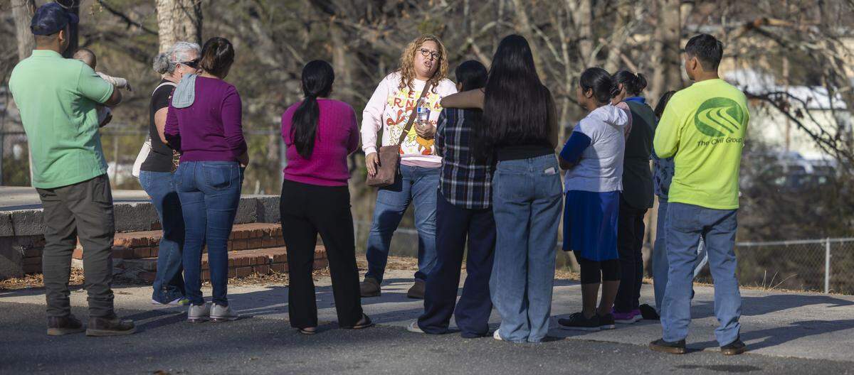 Katia Roebuck, with the NC Congress of Latino Organizations, talks with concerned residents of the Chatham Estates Mobile Home Park during a meeting on Wednesday, December 24, 2025 in Cary, N.C. Many in the community have grown concerned after rumors of potential eviction notices have circulated among them in the closing days of 2025. 