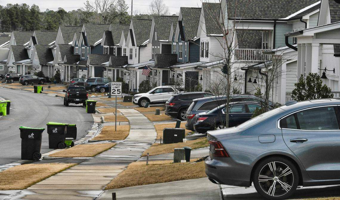 Tightly grouped houses line a street in a subdivision in New Hill, N.C. Monday, January 17, 2022.