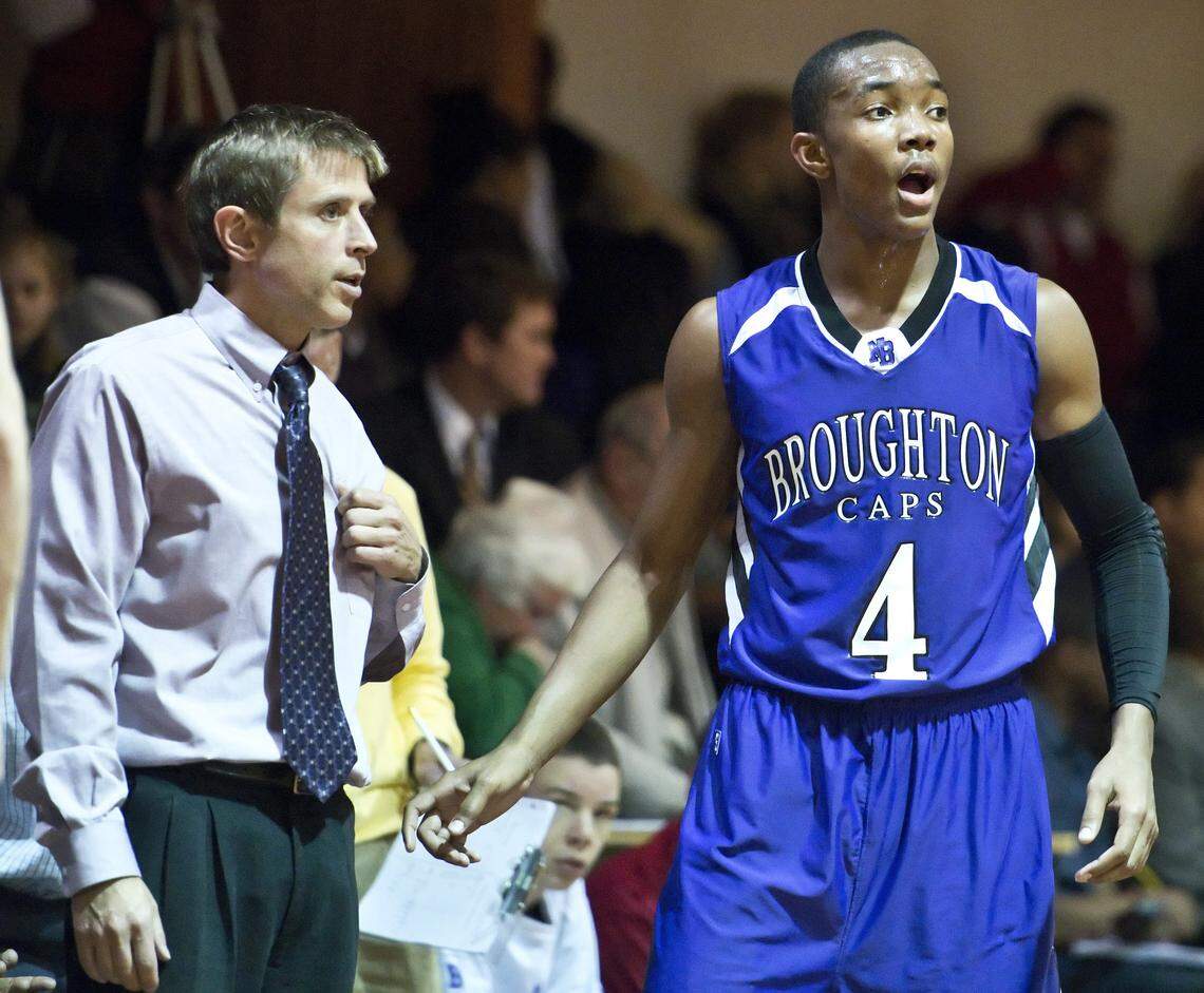 In this 2012 photo, Broughton head coach Jeff Ferrell talks to Broughton senior Devonte’ Graham (4) during a game at Cardinal Gibbons.