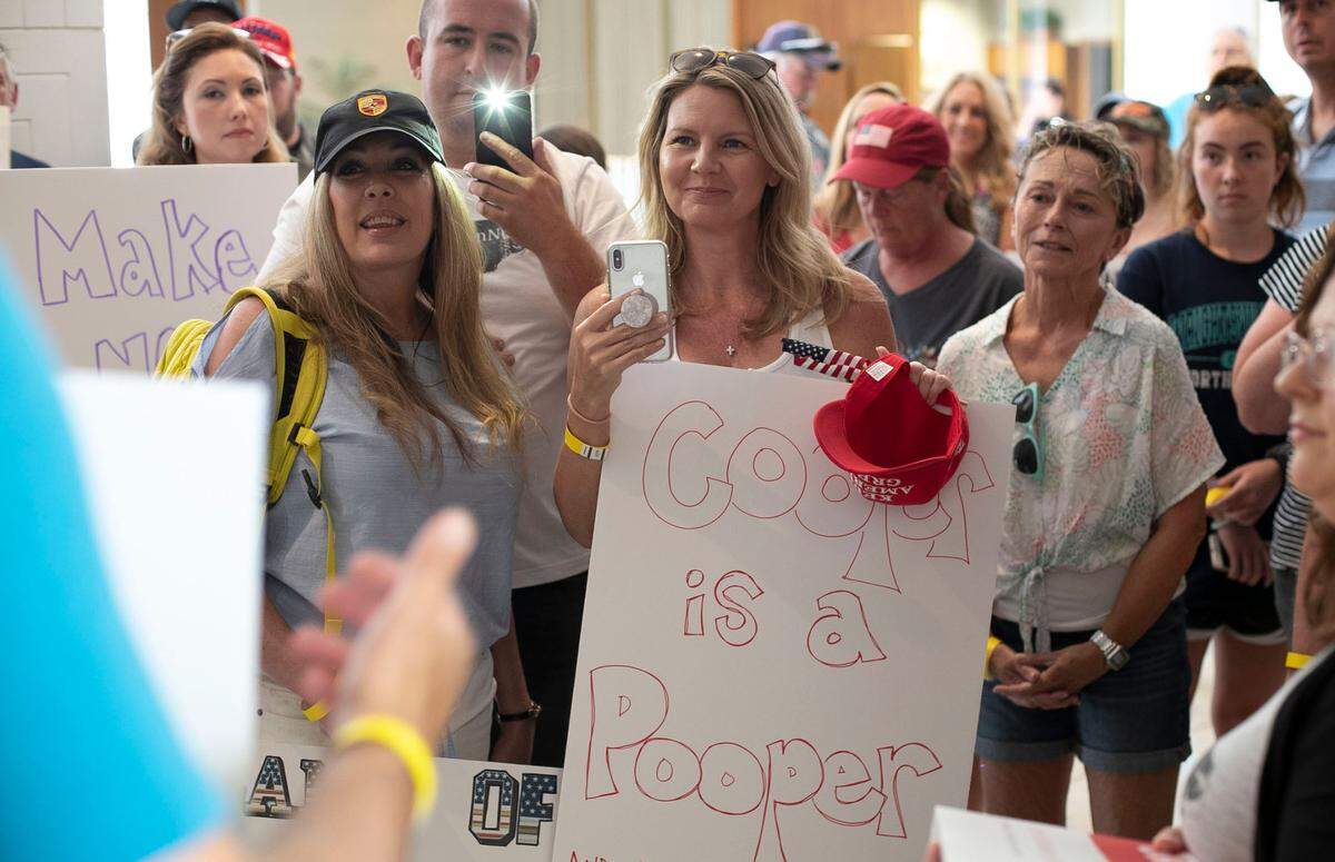 ReopenNC protesters gather at North Carolina House Speaker Tim Moore’s office asking lawmakers to block the mask requirement and to investigate Gov. Roy CooperÕs executive order on Friday, June 26, 2020 in Raleigh, N.C.