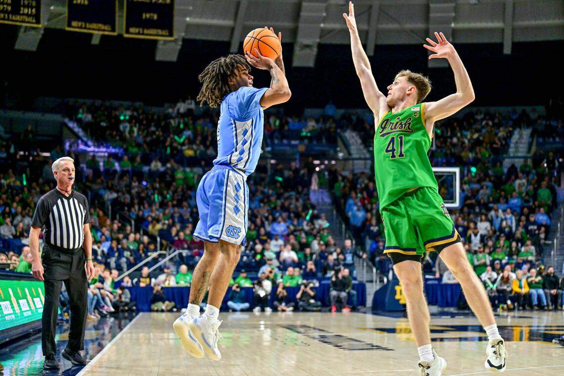 North Carolina Tar Heels guard Elliot Cadeau (3) shoots a three-point basket as Notre Dame Fighting Irish guard Matt Allocco (41) defends in the second half at the Purcell Pavilion.