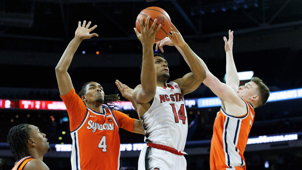N.C. State’s Casey Morsell drives to the basket past Syracuse’s Chris Bell and Justin Taylor during the first half of the Wolfpack’s game on Tuesday, Feb. 20, 2024, at PNC Arena in Raleigh, N.C.