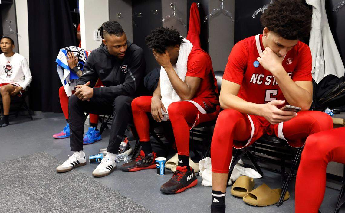 N.C. State graduate manager Torin Dorn talks with Jarkel Joiner in the locker room after Creighton’s 72-63 victory over N.C. State in the first round of the NCAA Tournament at Ball Arena in Denver, Colo., Friday, March 17, 2023. N.C. State’s Jack Clark sits to the right.