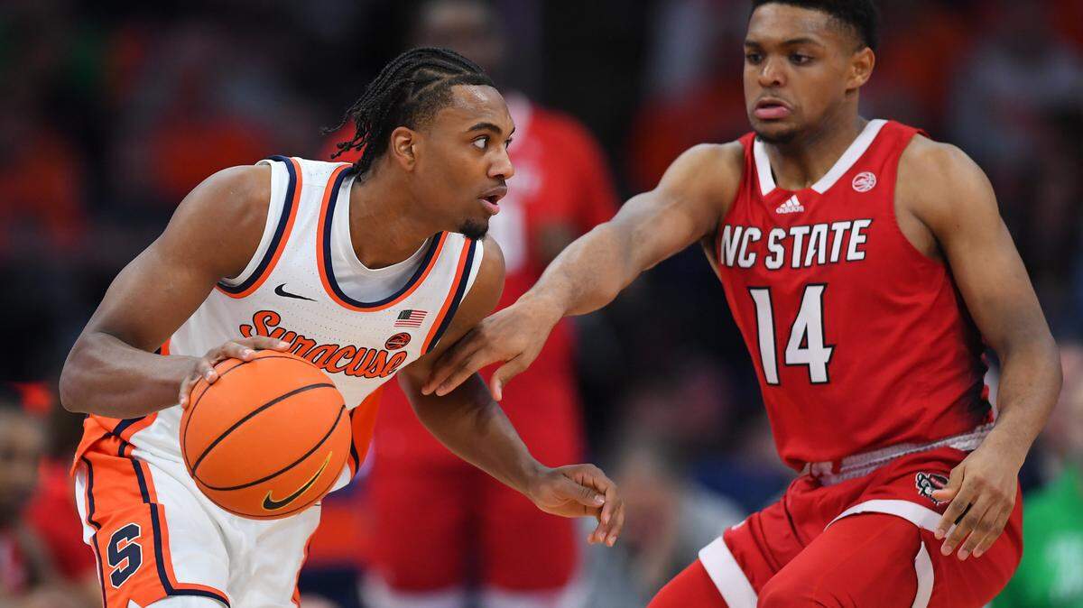 Jan 27, 2024; Syracuse, New York, USA; Syracuse Orange guard JJ Starling (2) drives to the basket as North Carolina State Wolfpack guard Casey Morsell (14) defends during the first half at the JMA Wireless Dome. Mandatory Credit: Rich Barnes-USA TODAY Sports