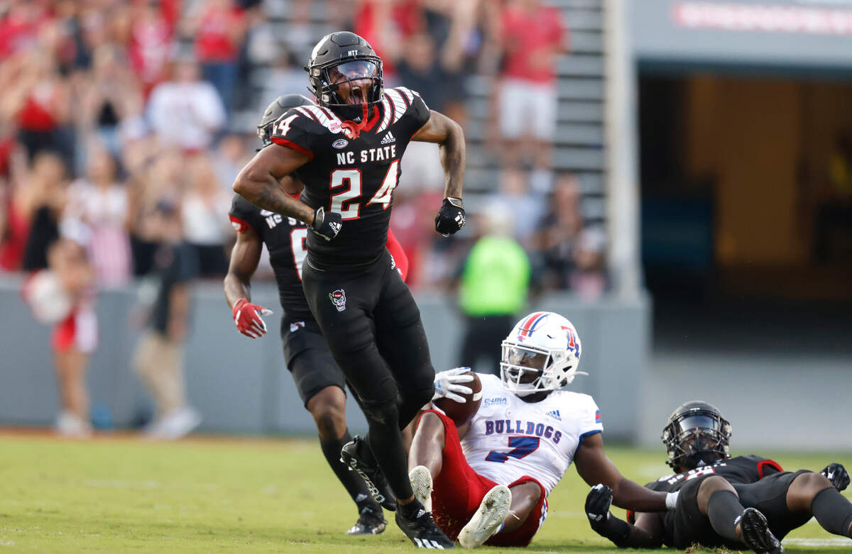 N.C. State cornerback Derrek Pitts Jr. (24) celebrates after stopping Louisiana Tech running back Marcus Williams Jr. (7) during the first half of N.C. State’s game against Louisiana Tech at Carter-Finley Stadium in Raleigh, N.C., Saturday, October 2, 2021.