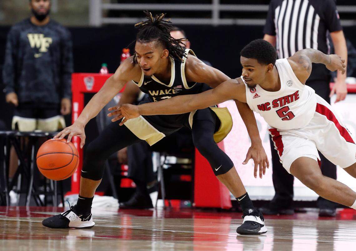 N.C. State’s Thomas Allen (5) tries to steal the ball from Wake Forest’s Jalen Johnson (2) during the second half of N.C. State’s 72-67 victory over Wake Forest at PNC Arena in Raleigh, N.C., Wednesday, January 27, 2021.