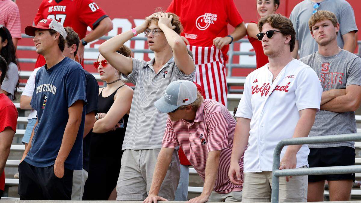 Fans react after Wake Forest made a first down late in the second half of Wake Forest’s 34-30 victory over N.C. State at Carter-Finley Stadium in Raleigh, N.C., Saturday, Oct. 5, 2024.