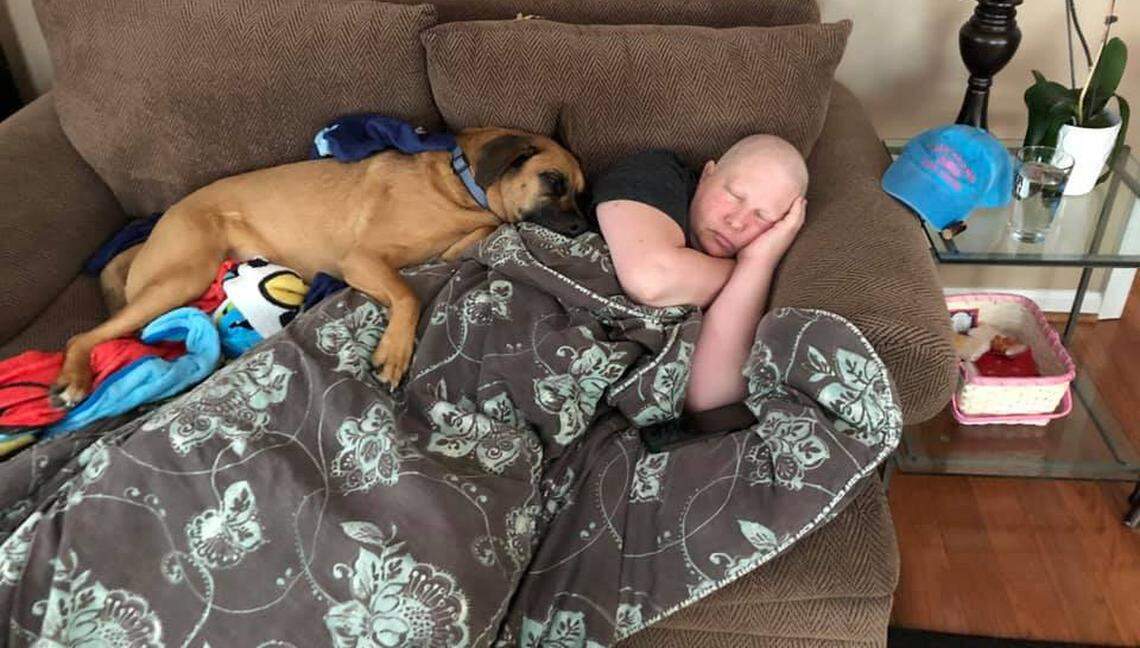 Jessaca Giglio and her dog Bon Jovi sleep after one chemo treatment.