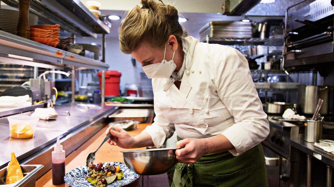 Chef Elizabeth Murray plates the roasted cauliflower with sweet potato, caper, date, pine nut and grape at Littler in Durham on Thursday, Feb. 24, 2022.