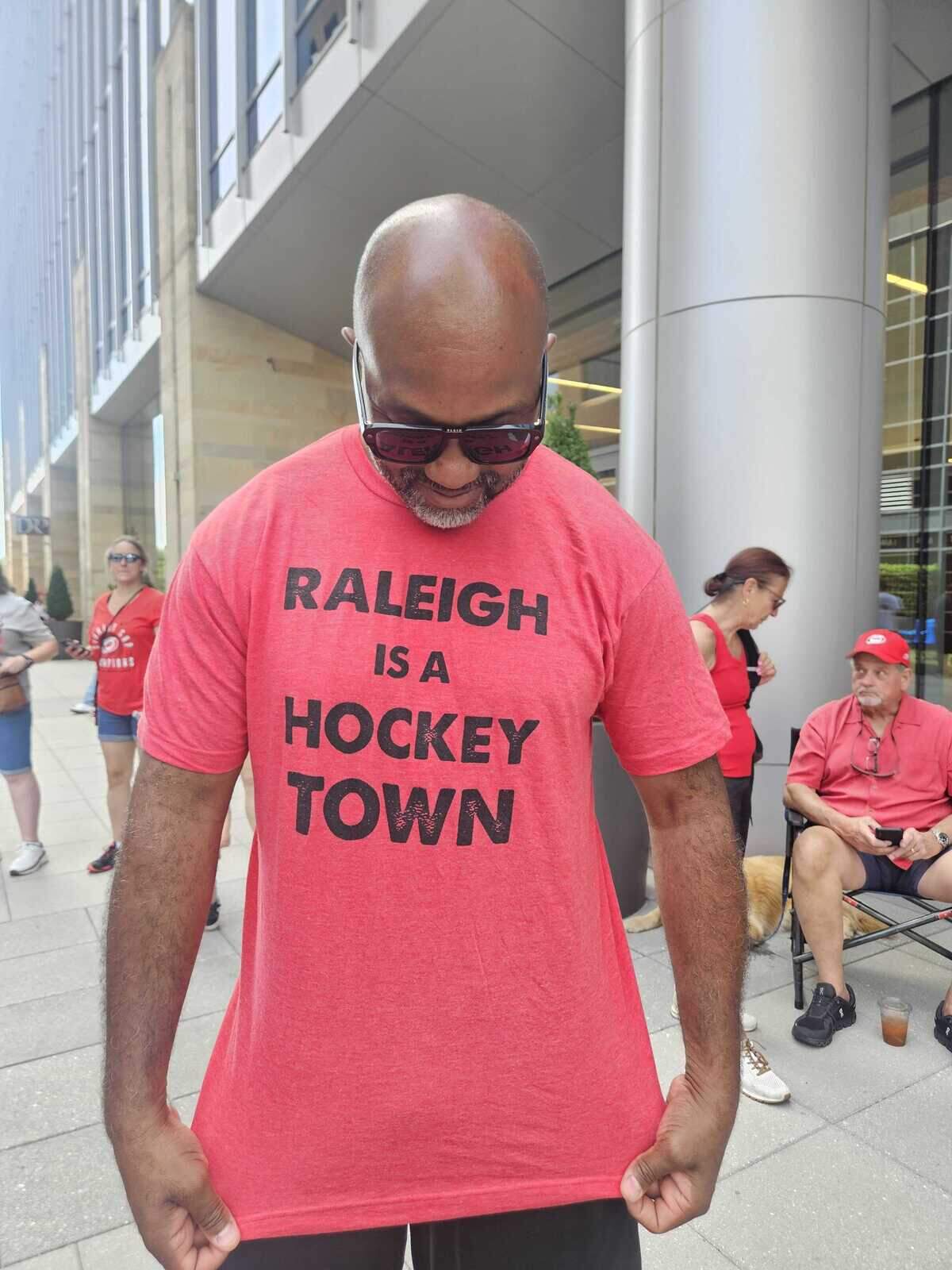 Former NC State and LA Rams player Torry Holt sports his shirt during the Stanley Cup parade in downtown Raleigh.
