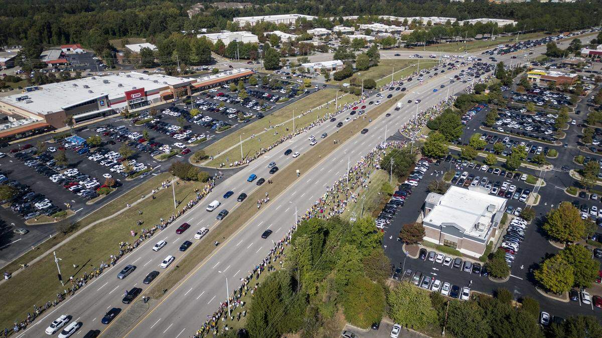 No Kings protesters line both sides of a section of Capital Blvd in Raleigh, N.C., Saturday, Oct. 18, 2025.