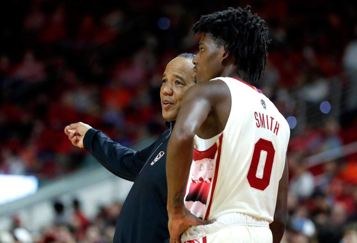 N.C. State head coach Kevin Keatts talks with Terquavion Smith (0) during the second half of Syracuse’s 89-82 victory over N.C. State at PNC Arena in Raleigh, N.C., Wednesday, Feb. 2, 2022.