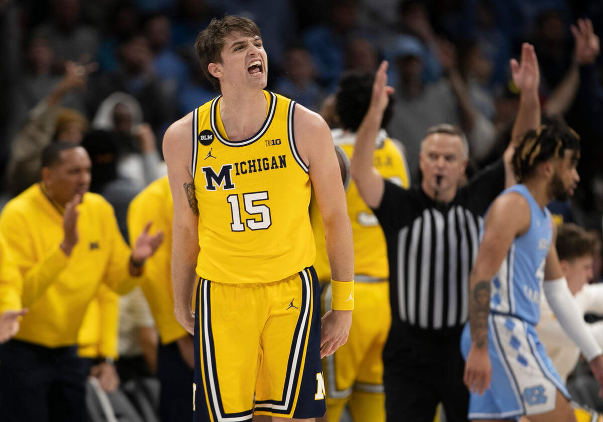 Michigan’s Joey Baker (15) reacts after sinking a three point basket to keep Michigan in the game, pulling the Wolverines to within three points with 3:37 to play on Wednesday, December 21, 2022 at the Spectrum Center in Charlotte, N.C.