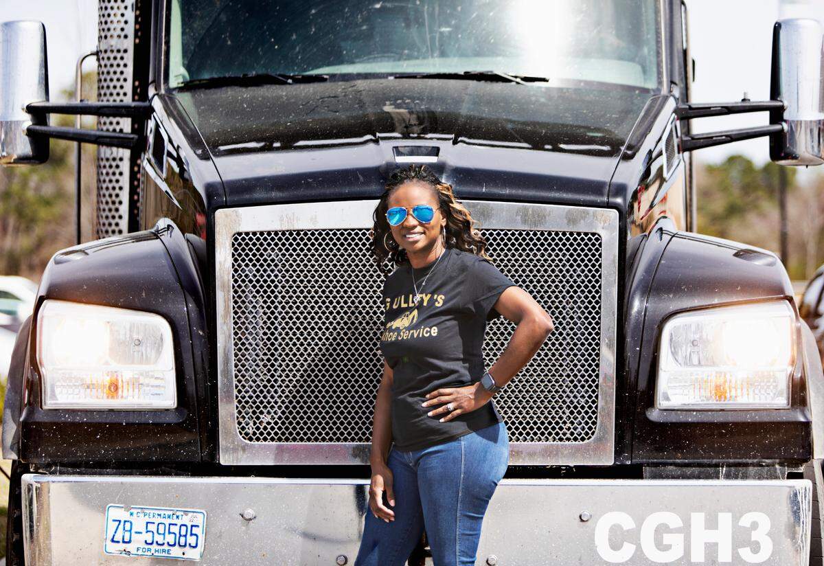 Candice Gulley Hines with one of the trucks that belongs to her family’s business, Gulley’s Backhoe Service, at a job site in Raleigh on Tuesday, March 22, 2022. Gulley Hines’ parents started the business in 1984 so she has grown up in the business and raised her daughter to work there as well.